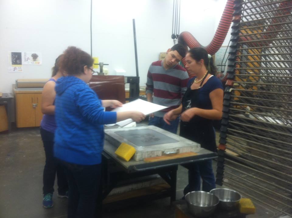 Art students assisting Laura in printing the lithograph